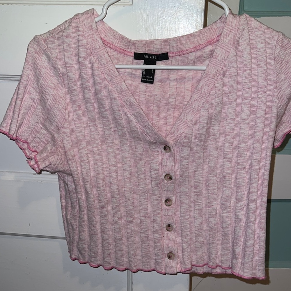 A pink buttoned crop top perfect for a windy day